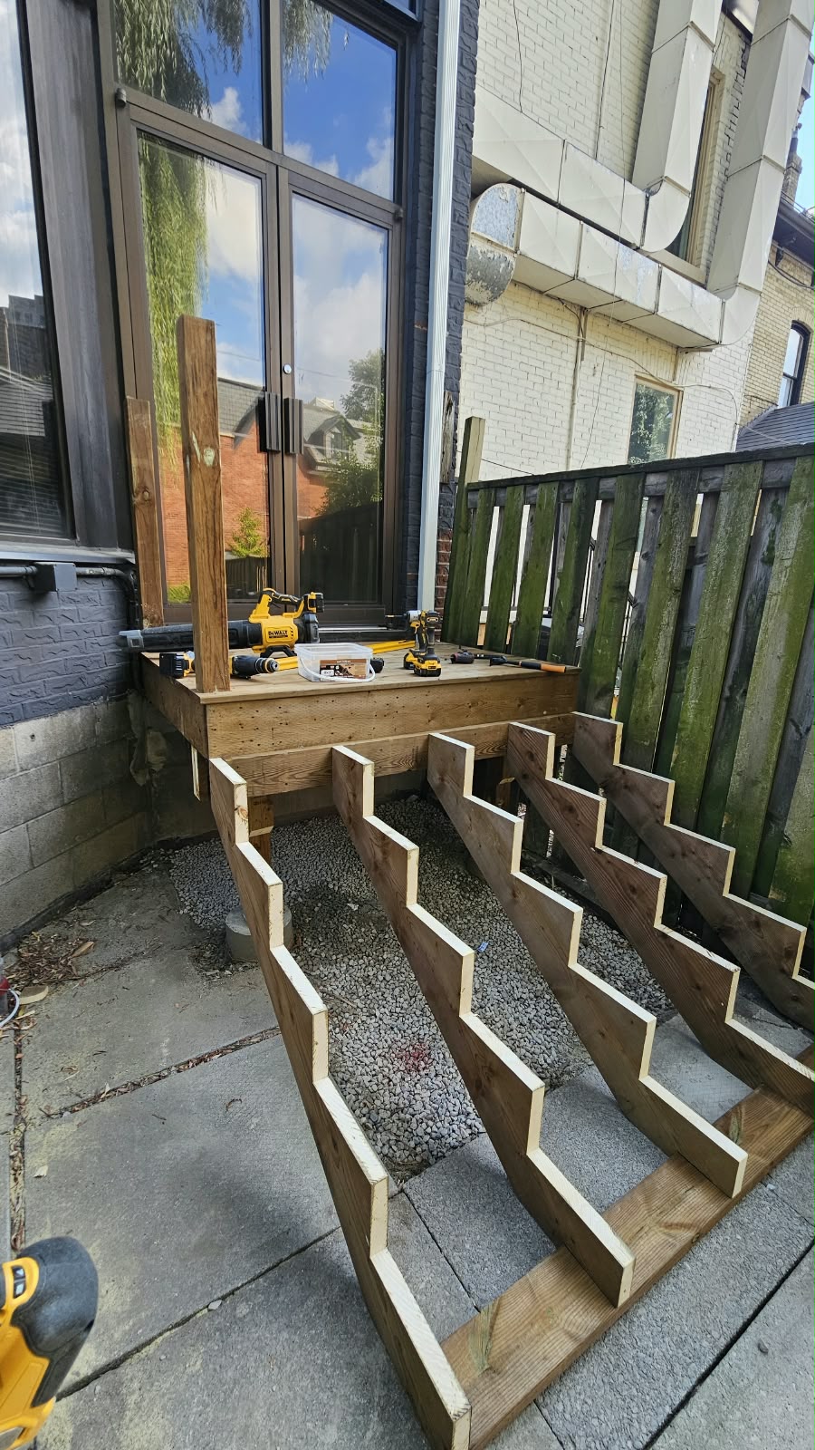 Framed exterior stairs and landing at a side entrance